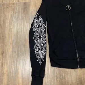 The Rare Chrome Hearts Floral Cross Track Jacket is a black zip-up track jacket featuring a floral cross design. This jacket is likely to be a limited edition or rare piece, and may be highly sought after by collectors and fans of the Chrome Hearts brand. The jacket is made of premium materials and is likely to be of high quality. The floral cross design is a unique and eye-catching feature that sets this jacket apart from other track jackets. It is likely to be a stylish and comfortable piece of clothing that can be dressed up or down depending on the occasion.